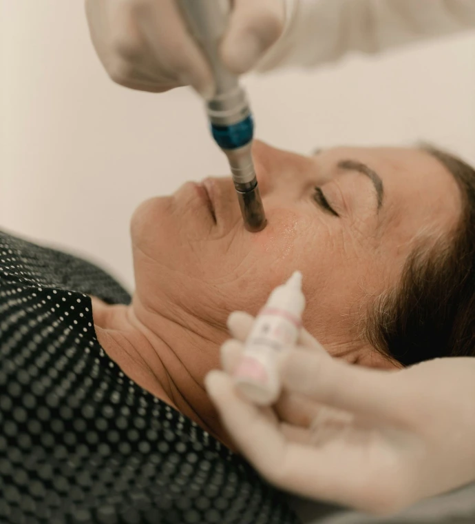 A woman getting a botilage injection from a doctor